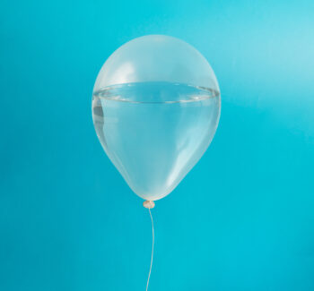 transparent balloon against blue background filled with water