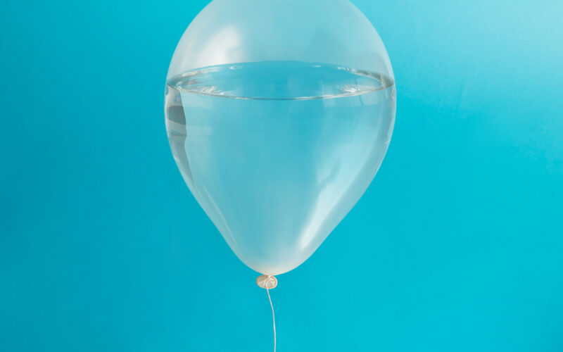 transparent balloon against blue background filled with water